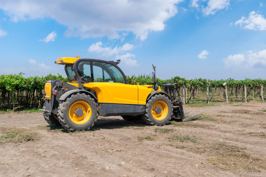 a rough terrain forklift truck in an open dusty field