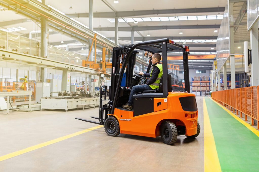 a warehouse worker operating a counterbalance type of forklift truck