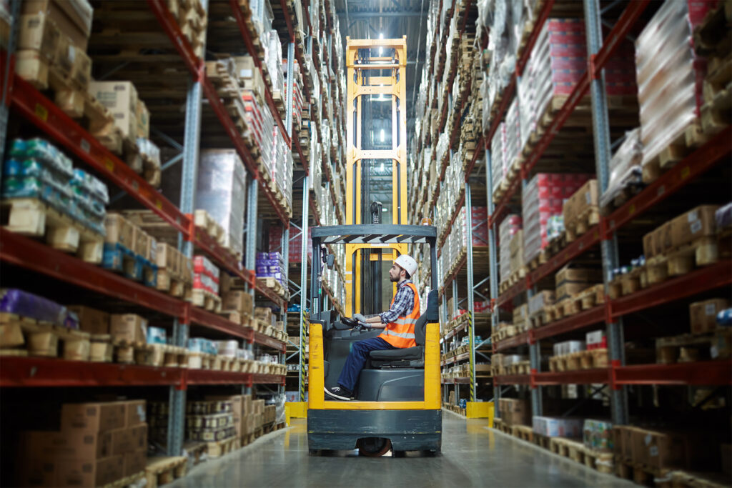 a warehouse worker operating a forklift truck
