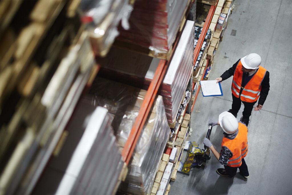a birds eye view of two works discussing warehouse efficiency whilst moving items from the racking